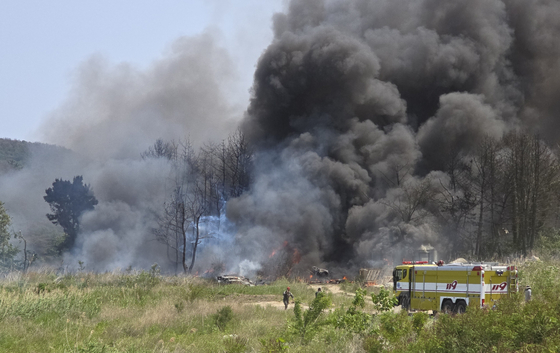 Smoke billows from the site where a Navy maritime patrol aircraft crashed in the southern district of Pohang, North Gyeongsang, on May 29. [YONHAP] 