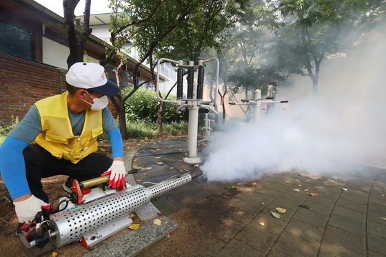 Deagu city officials spray mosquito repellent smoke in southern Daegu on Aug. 8, 2024. [NEWS1]