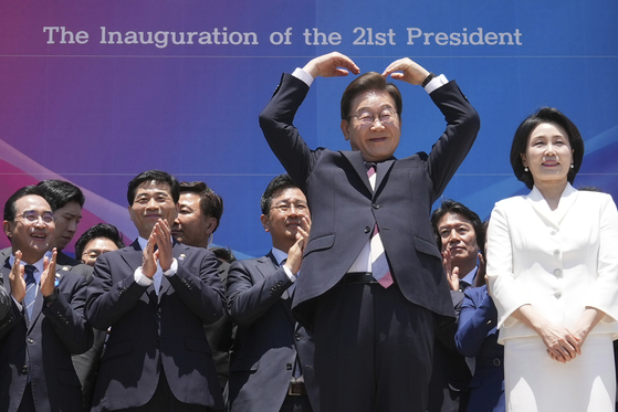 Korean new President Lee Jae-myung, front left, and his wife Kim Hea Kyung greet to the people after attending the presidential inauguration at the National Assembly in Seoul on June 4. [AP/YONHAP]