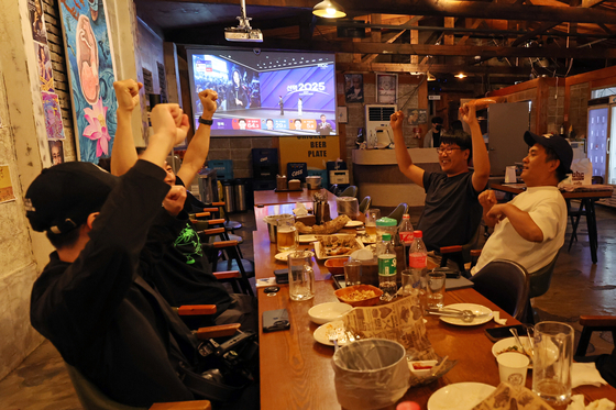 People watch coverage of the vote count for Korea's 21st presidential election at a bar in Dong District, Gwangju, on June 3. [YONHAP] 