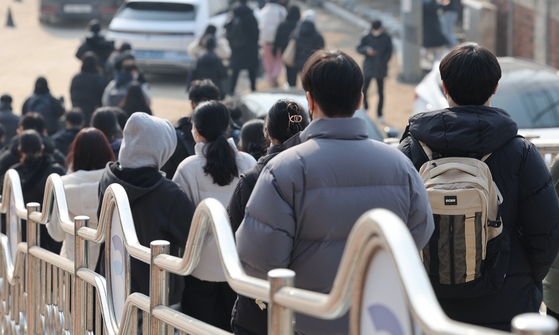 Test-takers exit an ETS testing center in Jongno District, central Seoul, on Feb. 5, 2023 [YONHAP] 