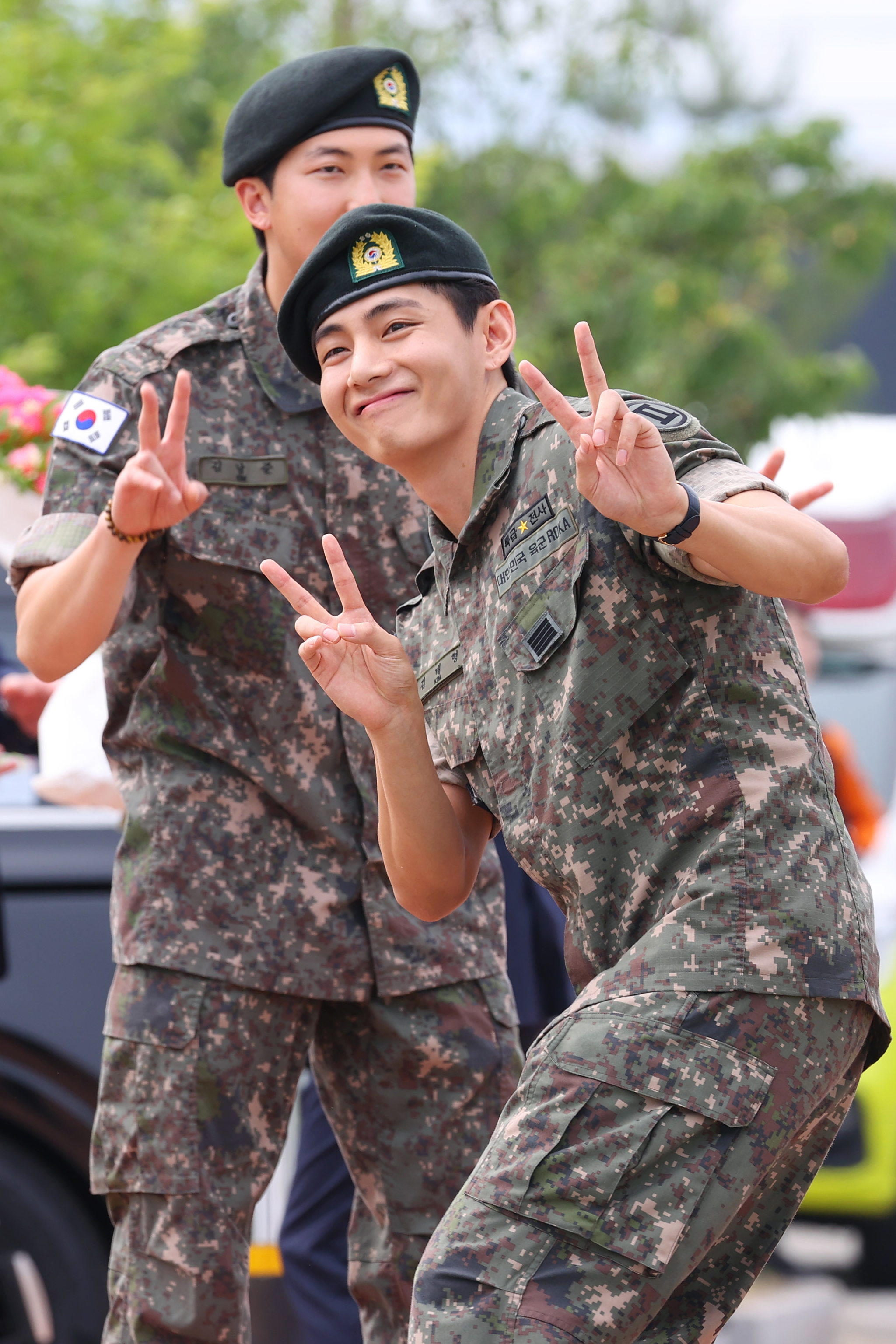 Members RM and V of boy band BTS post for photos in joy after finishing their military duties on June 10 in Gangwon. [YONHAP]