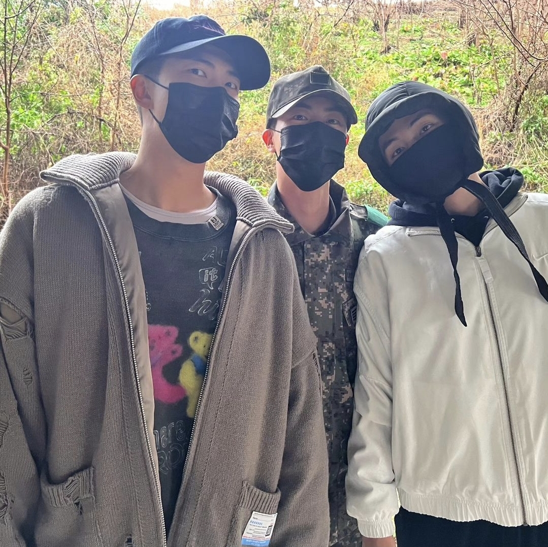 BTS's Jin, center, poses for the camera with RM, left, and V, who began their military service on Dec. 11, 2023. [SCREEN CAPTURE]
