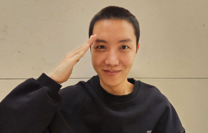 J-Hope poses after getting his hair cut short in preparation for military enlistment in a photo he uploaded on Weverse on April 17, 2023, a day before he began his military service. [WEVERSE]