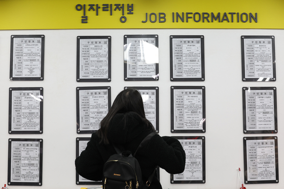 A job seeker looks at notices at a welfare center in western Seoul on March 17. [YONHAP]