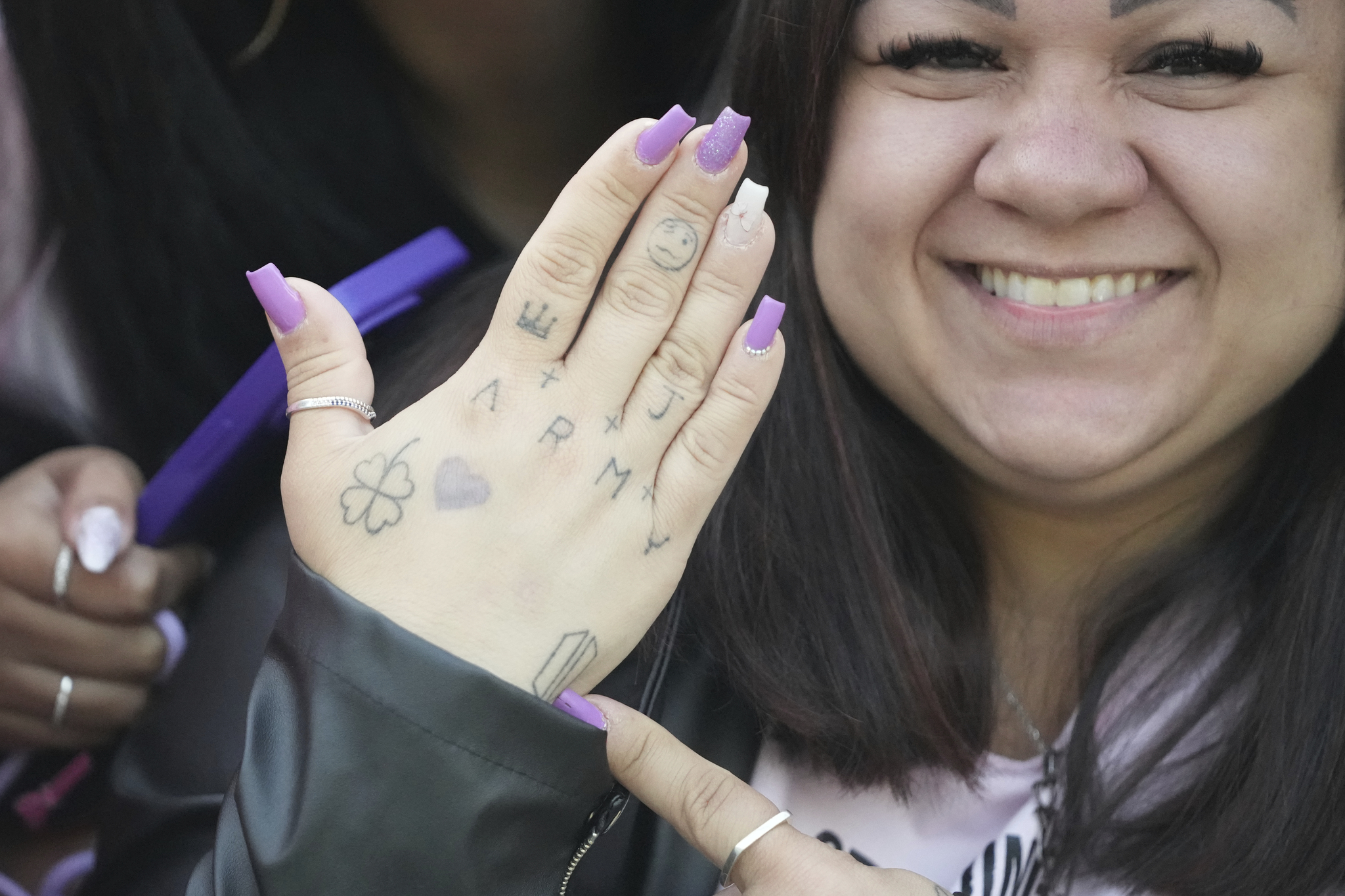 Daiane Matos from Brazil, 37, shows her hand as she waits for the arrival of K-pop band BTS members Jimin and Jungkook in Yeoncheon, Gyeonggi, on June 11, 2025. [AP/YONHAP]