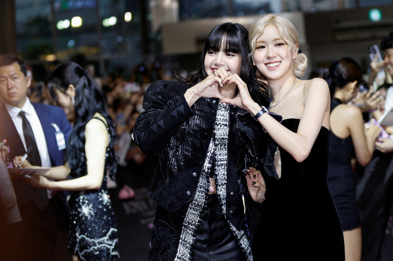 Rose, right, and Lisa from the K-pop girl group Blackpink pose at the premiere of their world tour film 'Born Pink' on Aug. 9, 2024. [REUTERS/YONHAP]