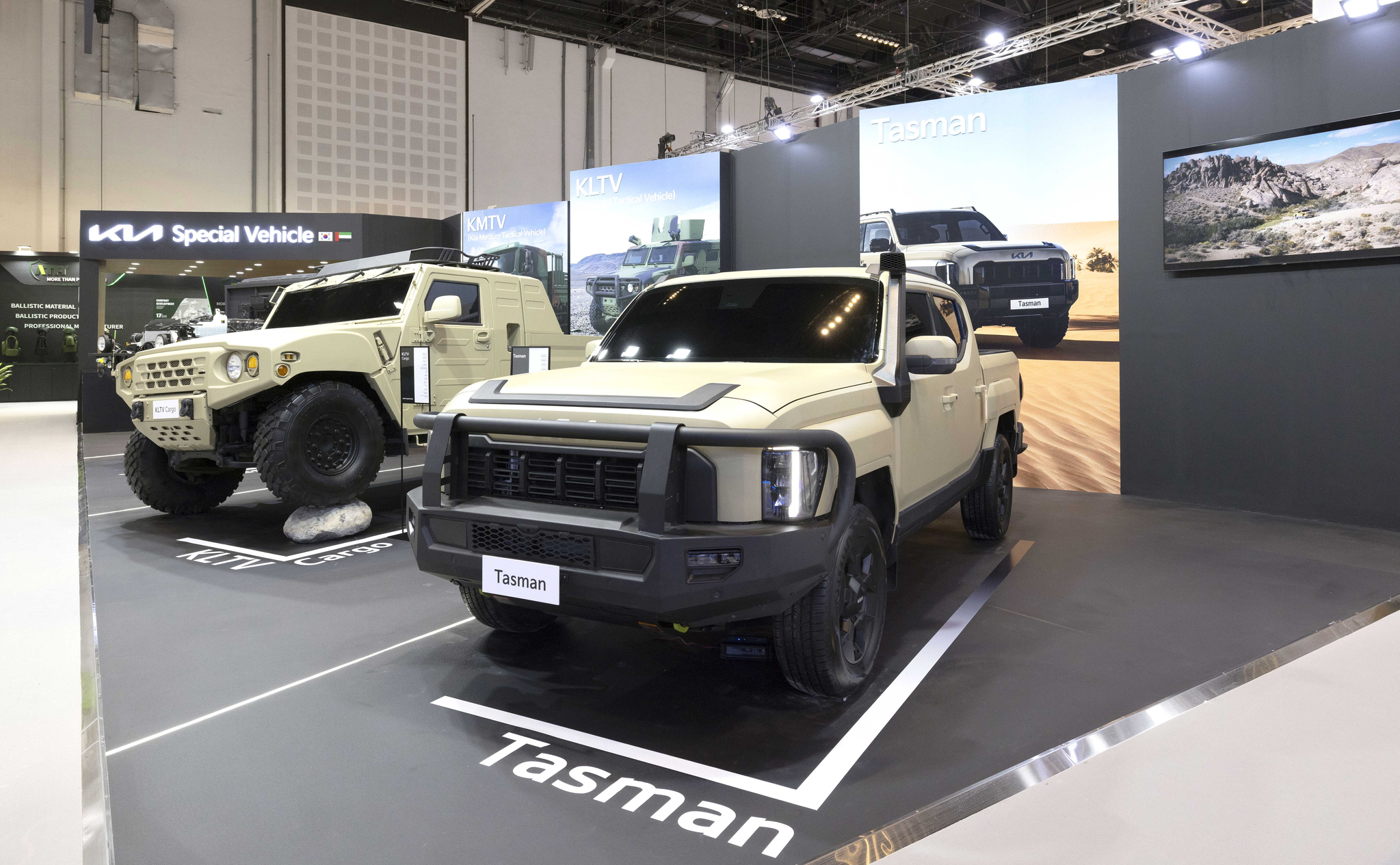 Kia's two-seat version of its Light Tactical Cargo Vehicle, left, and Tasman are displayed at the company’s booth during the 2025 International Defence Exhibition & Conference in Abu Dhabi, United Arab Emirates in February. [KIA] 