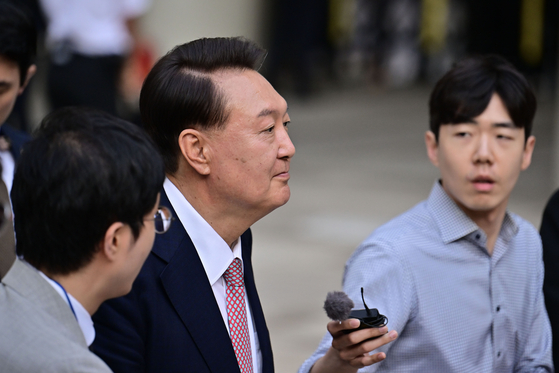 Former President Yoon Suk Yeol speaks to reporters as he leaves the Seoul Central District Court in Seocho District, southern Seoul, on June 9, after attending the sixth hearing in his trial on charges of leading a rebellion and abuse of power. [JOINT PRESS CORPS]