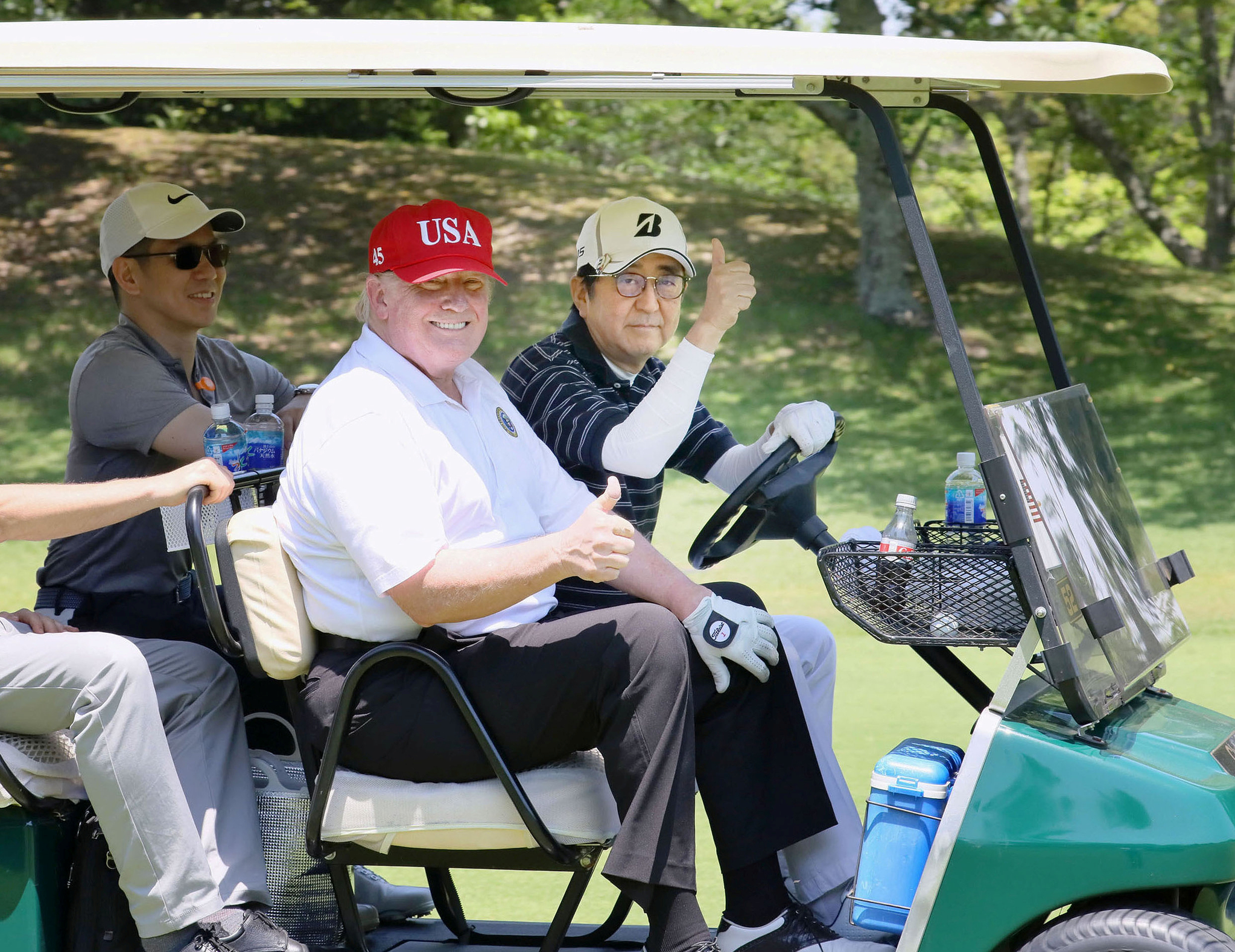 U.S. President Donald Trump rides a golf cart as Japanese Prime Minister Shinzo Abe drives while they play golf at Mobara Country Club in Mobara, Chiba prefecture, Japan, in this photo released by Japan's Cabinet Public Relations Office via Kyodo May 26, 2019.[KYODO/YONHAP]