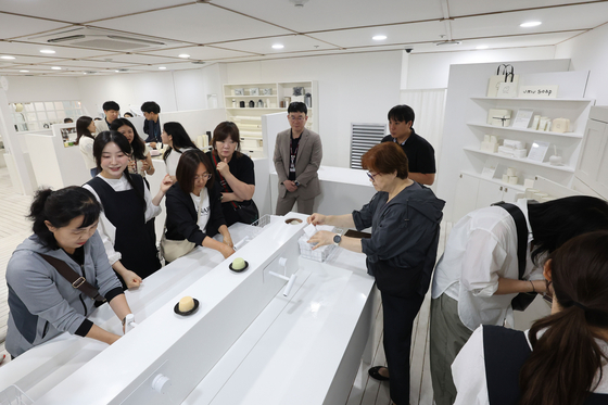 Visitors look around items made by ingredients native to Jeju Island at a booth at Jeju International Airport on June 12. [JOINT PRESS CORPS]