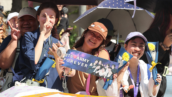 Fans of BTS, called ARMY, celebrate BTS members Jimin and Jungkook's return from military service in front of HYBE's headquarters in Yongsan District, central Seoul, on June 11. [YONHAP] 