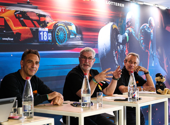 Cyril Abiteboul, head of Hyundai Motorsport and director of Genesis Magma Racing, Luke Donkerwolke, chief design and creative officer at Hyundai Motor Group, and Jacky Ickx, Genesis brand partner and Magma racing adviser, speak to reporters at the 24 Hours of Le Mans in France on June 13. [HYUNDAI MOTOR GROUP] 