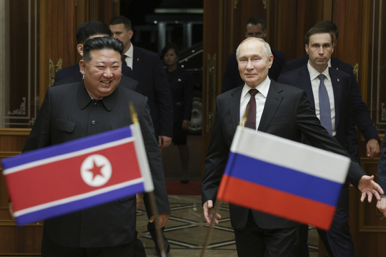 Russian President Vladimir Putin, right, and North Korea's leader Kim Jong-un smile during their meeting at the Pyongyang Sunan International Airport outside Pyongyang, North Korea, on June 19, 2024. [AP/YONHAP]
