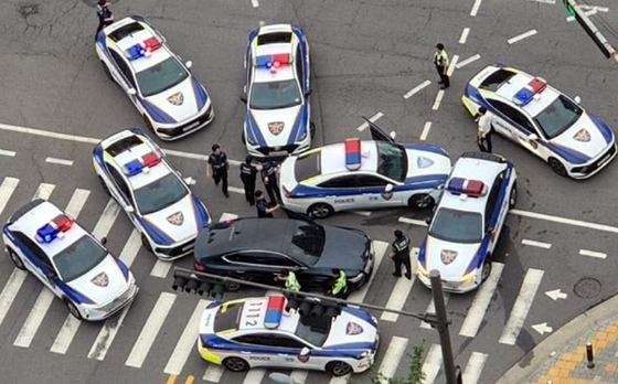 A driver who crashed into six police cars while driving 13 kilometers (8 miles) is encircled by police in Danwon District, Ansan, Gyeonggi, on June 17, in this photo provided by a reader to Yonhap. [YONHAP] 