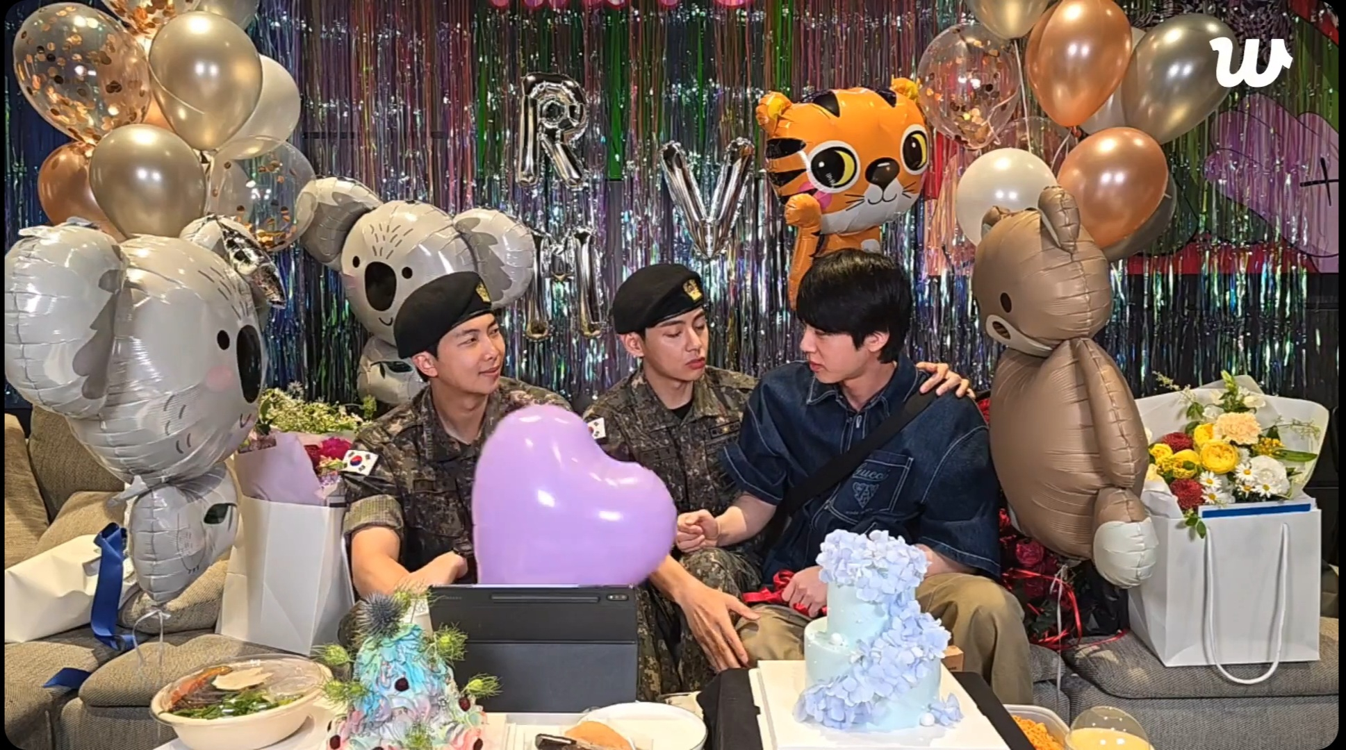 BTS member Jin, center, appears during a Weverse livestream marking the discharge of RM, left, and V, right, on June 10. [SCREEN CAPTURE]