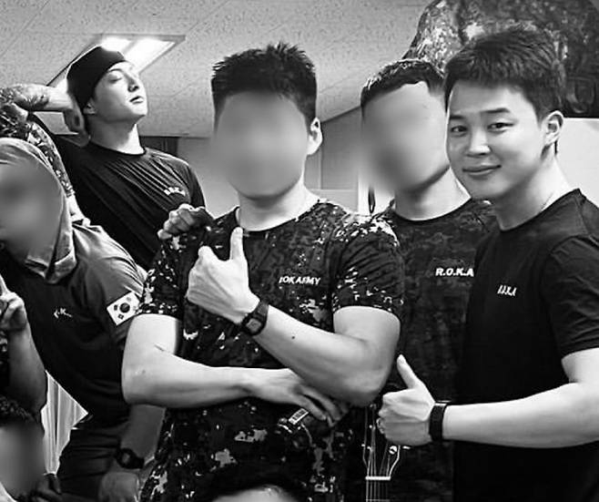 BTS members Jungkook and Jimin appear in a group photo with their fellow soldiers uploaded online in October 2024. [SCREEN CAPTURE]