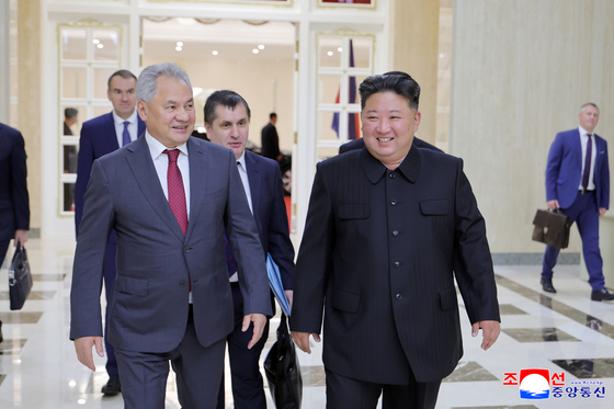 North Korean leader Kim Jong-un, right, and Russian Security Council Secretary Sergei Shoigu walk side by side in this image published by the Korean Central News Agency on June 18. [YONHAP]