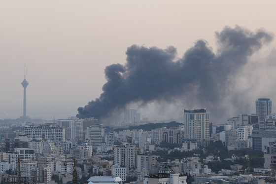 Smoke rises following an Israeli attack on the IRIB building, the country's state broadcaster, in Tehran, Iran, June 16, 2025. [REUTERS/YONHAP]