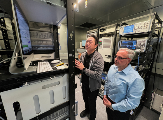 Johny Srouji, right, senior vice president of hardware technologies at Apple, and an Apple engineer view testing data on Apple's new C1 cellular modem in a shield room that blocks interference from cellular networks at Apple's wireless labs, in Sunnyvale, California, Feb. 18. [REUTERS/YONHAP] 