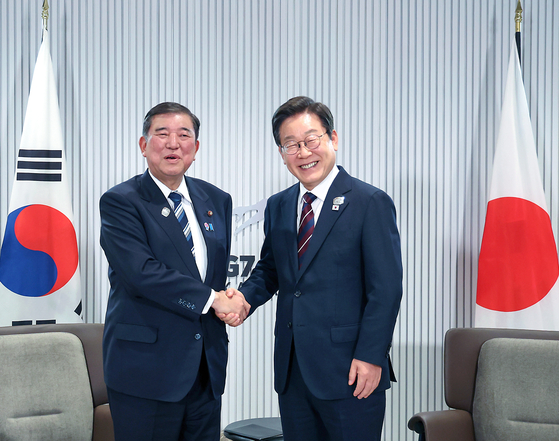 President Lee Jae Myung and Japanese Prime Minister Shigeru Ishiba shake hands during a Korea-Japan summit on June 17 on the sidelines of the Group of 7 summit in Kananaskis, Alberta, Canada. [JOINT PRESS CORPS]