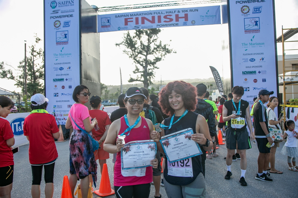 Travelers pose for a photo after completing the Saipan Marathon, which was part of Yellow Balloon tour's package tour. [YELLOW BALLOON TOUR]