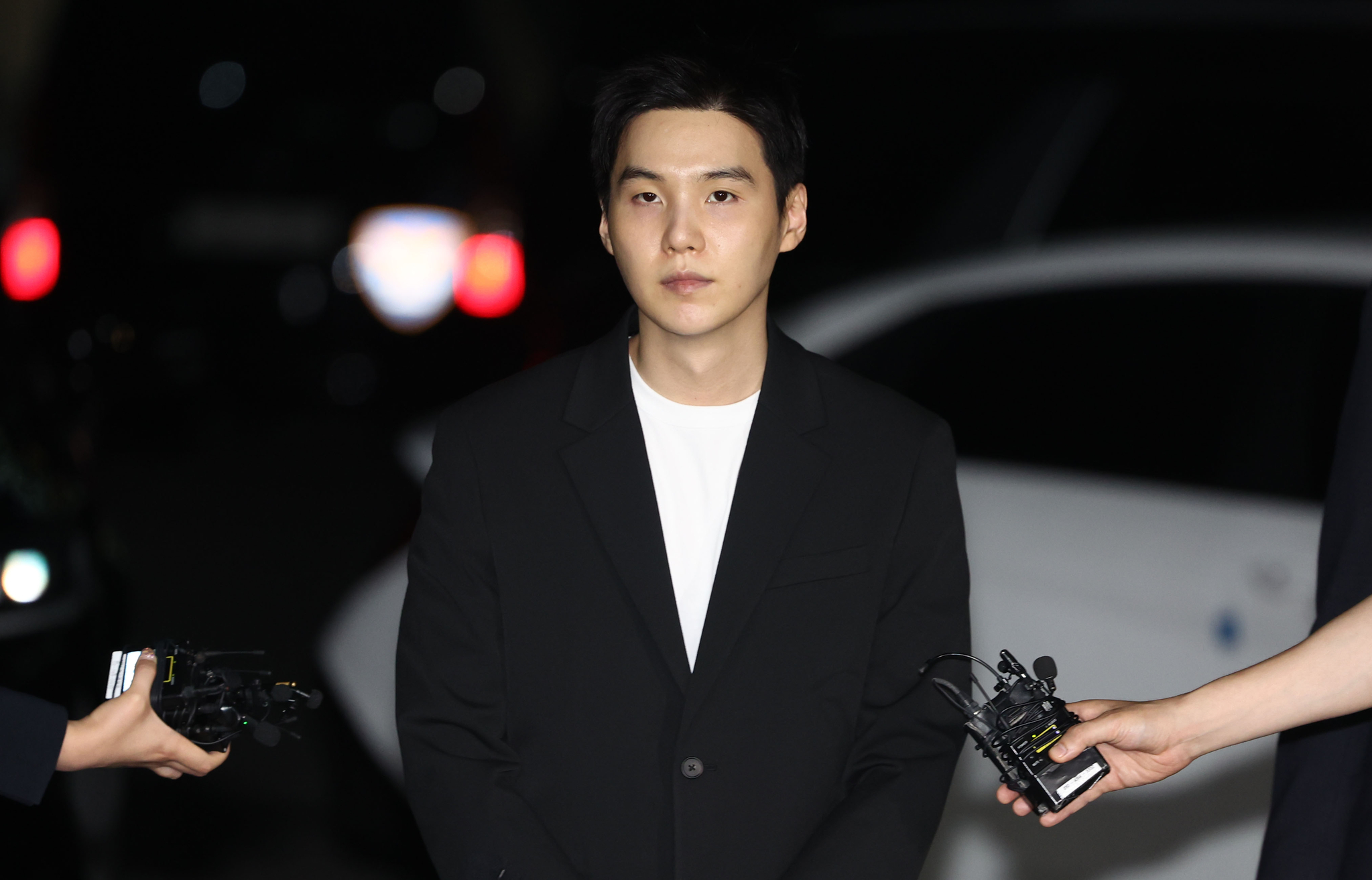 Suga of boy band BTS arrives at the Yongsan Police Precinct in central Seoul on Aug. 23, 2024. [YONHAP]   