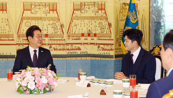 President Lee Jae Myung, left, speaks to People Power Party interim chief Kim Yong-tae, during a bipartisan luncheon held at his official residence in Hannam-dong, central Seoul, on June 22. [JOINT PRESS CORPS] 