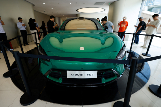 People look at the new electric SUV YU7 displayed at a Xiaomi store in Beijing, China on May 29. [REUTERS/YONHAP]