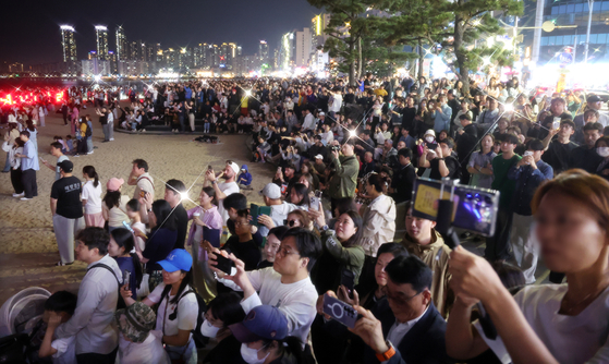 Spectators watch a drone show at Gwangalli Beach in Suyeong District, Busan, on May 31. [YONHAP] 