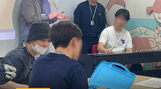 BTS member Suga visits Severance Hospital to volunteer his musical talent while serving as a social service worker in this screen capture of a video uploaded to the hospital's YouTube channel. [SCREEN CAPTURE]