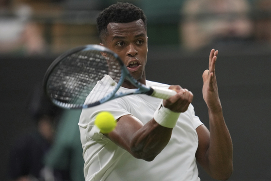 Giovanni Mpetshi Perricard of France returns the ball to Taylor Fritz of the United States during their first round men's single match at the Wimbledon Tennis Championships in London, June 30. [AP/YONHAP]