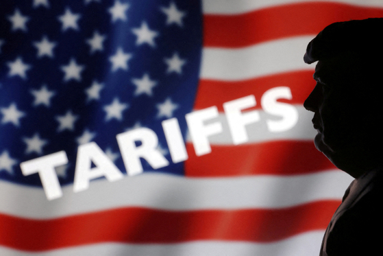A 3D-printed miniature model of U.S. President Donald Trump, U.S. Flag and word ″Tariffs″ are seen in this illustration taken, April 2, 2025. [REUTERS/YONHAP]