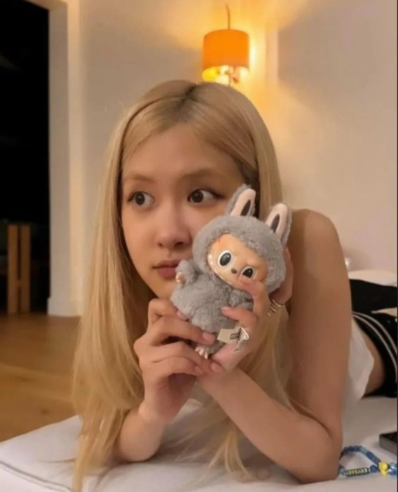 Blackpink member Rose holds up Pop Mart's Labubu plushie in this photo uploaded to Instagram [SCREEN CAPTURE]