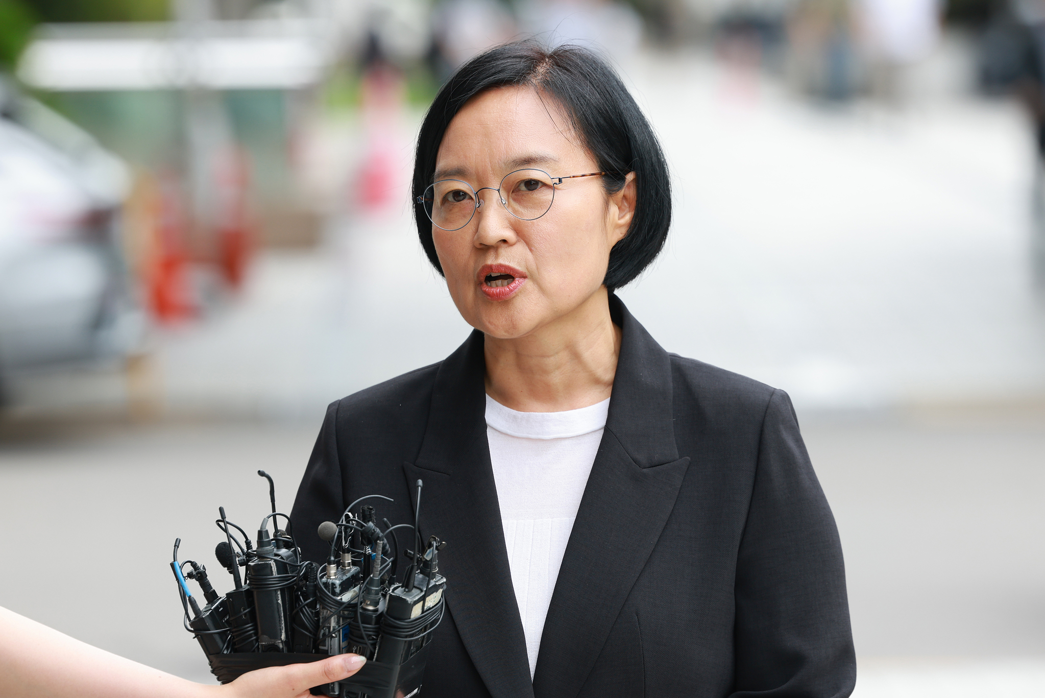 Han Seong-sook, the nominee for minister of small and medium-sized enterprises (SMEs) and startups, speaks to reporters upon arrival at her office in Seoul on June 24. [YONHAP]
