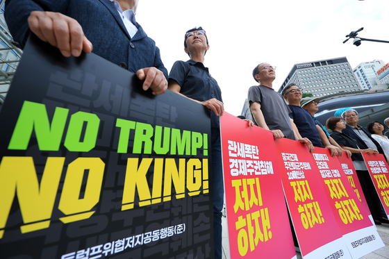 Activists hold a protest against the reciprocal tariffs of the Donald Trump administration in front of Post Tower in Jung District, central Seoul, on June 30. [NEWS1]