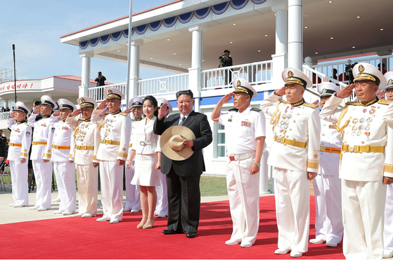 North Korean leader Kim Jong-un, center, attends a launch ceremony on June 12 at the Najin Shipyard for a newly built navy destroyer, which has been named Kang Kon, according to a report by the state-run Korean Central News Agency on June 13. [YONHAP]