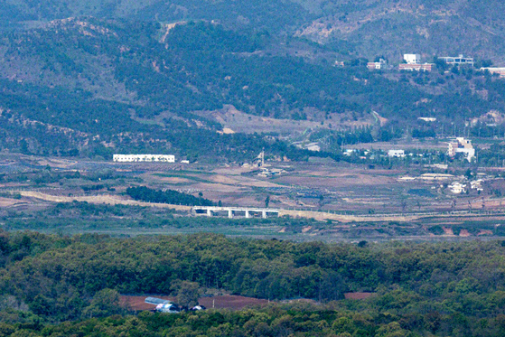 A quiet stretch of the demilitarized zone along the western front is seen from Paju, South Korea, on May 2, showing barriers North Korea installed on the Gyeongui Line road. [YONHAP] 
