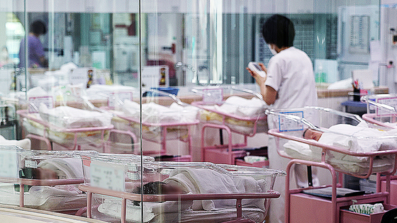 A nurse looks after newborns at a hospital in Seoul on Feb. 28, 2024. [YONHAP] 