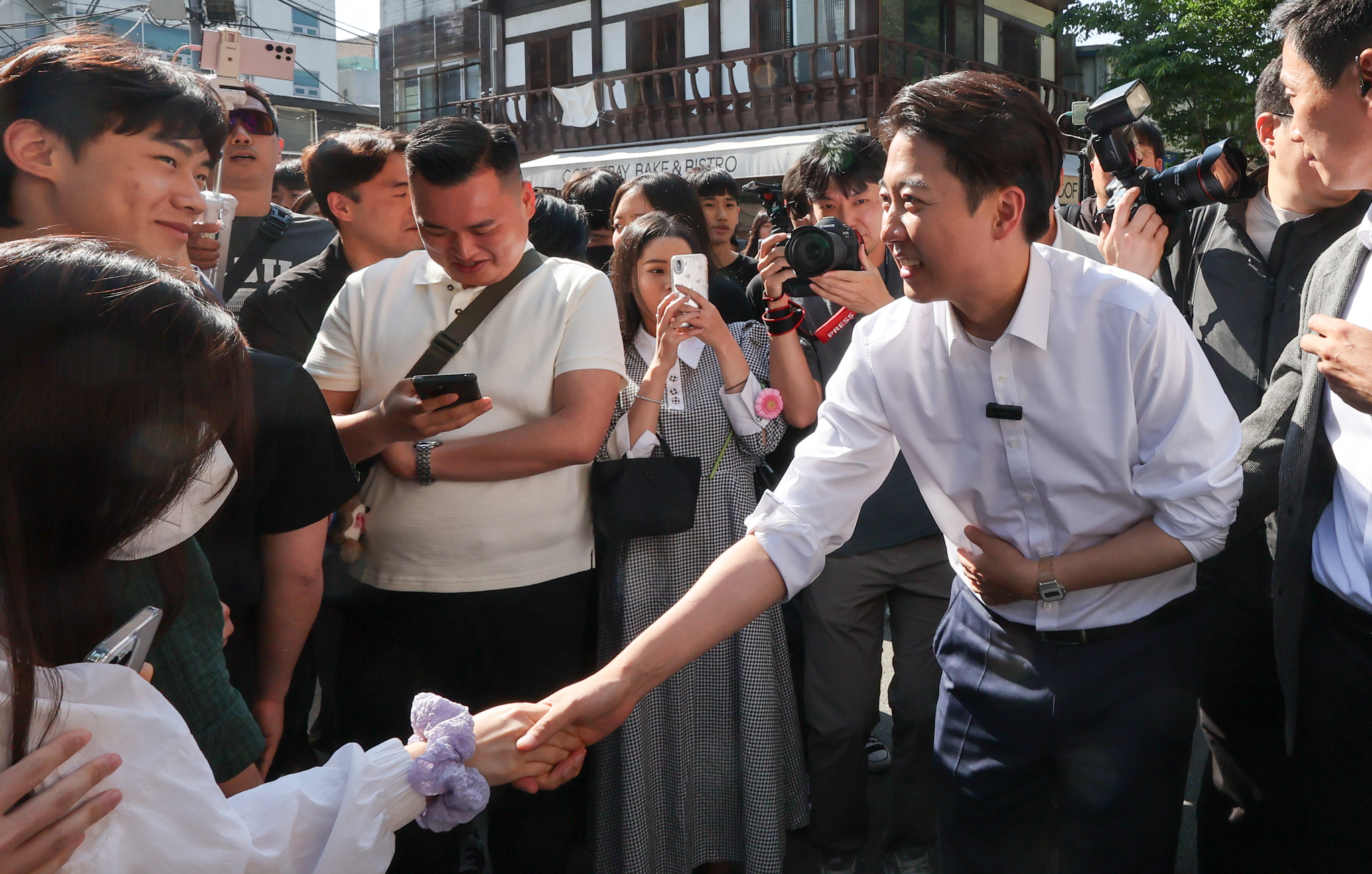 Lee Jun-seok, the minor Reform Party's candidate in the June presidential election, shakes hands during a campaign event in Jongno District, central Seoul, on May 25. According to a joint exit poll by terrestrial broadcasters KBS, MBC and SBS, over a third of men in the 20s voted for him compared to just 4 percent of women in the same age group. [NEWS1]