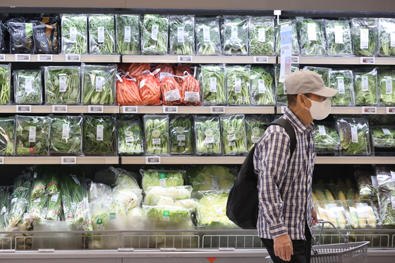 A shopper browses the vegetable and fresh produce section at a large supermarket in Seoul on July 6. Due to sweltering heat wave and lingering monsoon rains, vegetable prices continue to rise. [YONHAP]