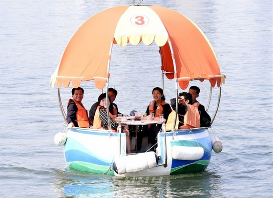 North Korean residents enjoy a ride along the Taedong River on a floating boat. [CHOSON SINBO/YONHAP]