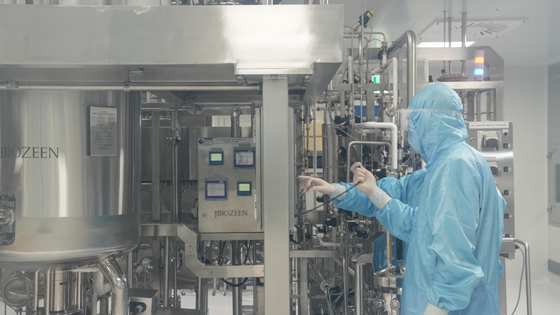 A researcher inspects anthrax vaccine manufacturing equipment at GC Biopharma Corp.'s vaccine production facility in Hwasun on July 1. [YONHAP]