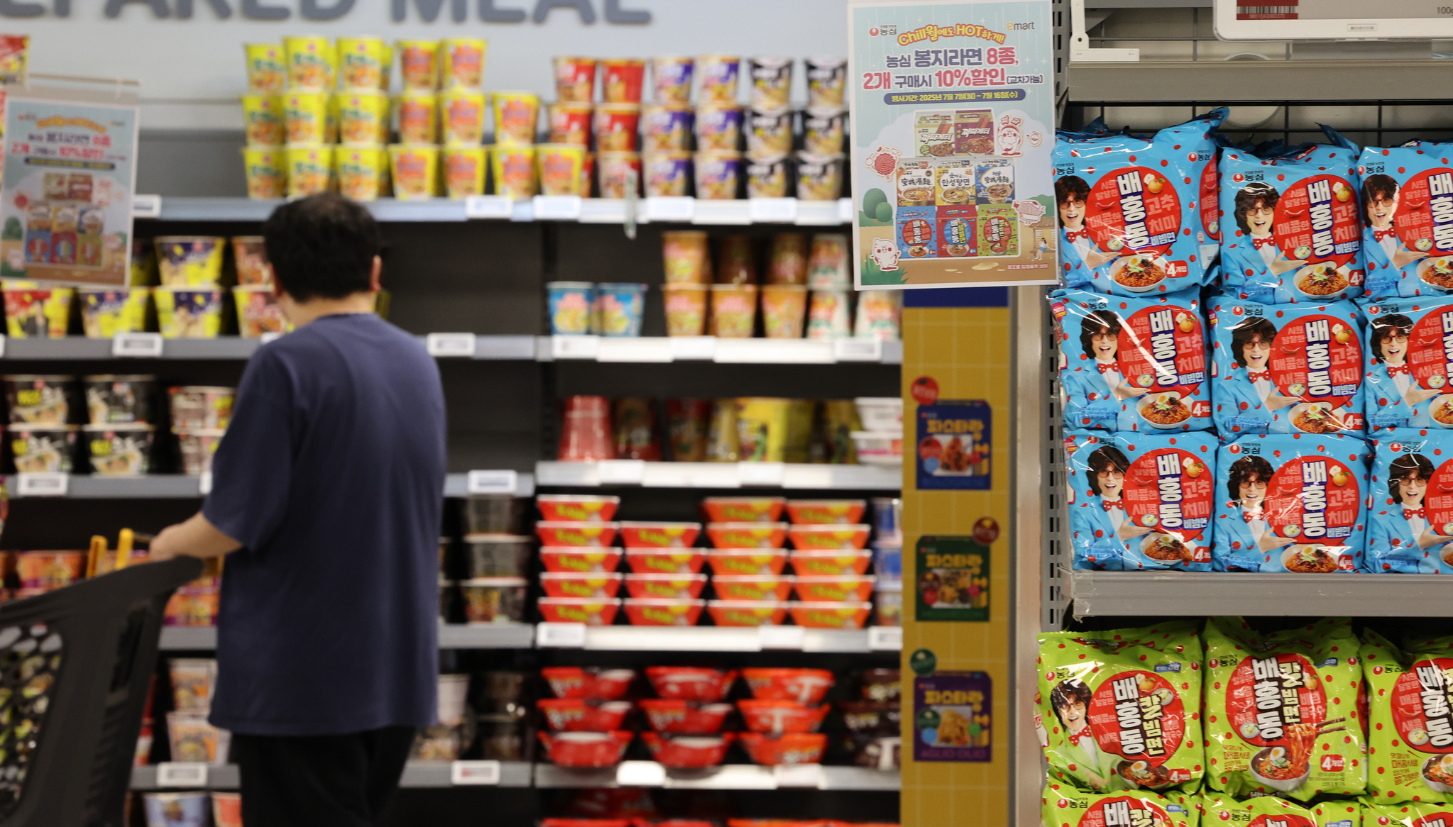 A customer looks at ramyeon (instant noodle) products stocked at a supermarket in Seoul on July 7. [YONHAP]