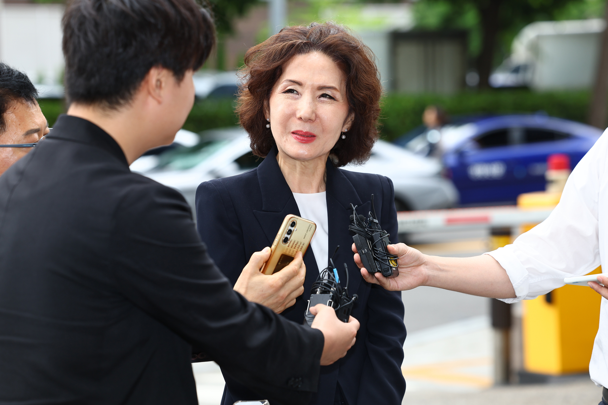 Vice Prime Minister for Social Affairs and Education Minister nominee Lee Jin-sook listens to questions from reporters as she arrives at her confirmation hearing preparation office at the Korea Institute of Educational Facility Safety in Yeouido, western Seoul, on the morning of June 30. [YONHAP]