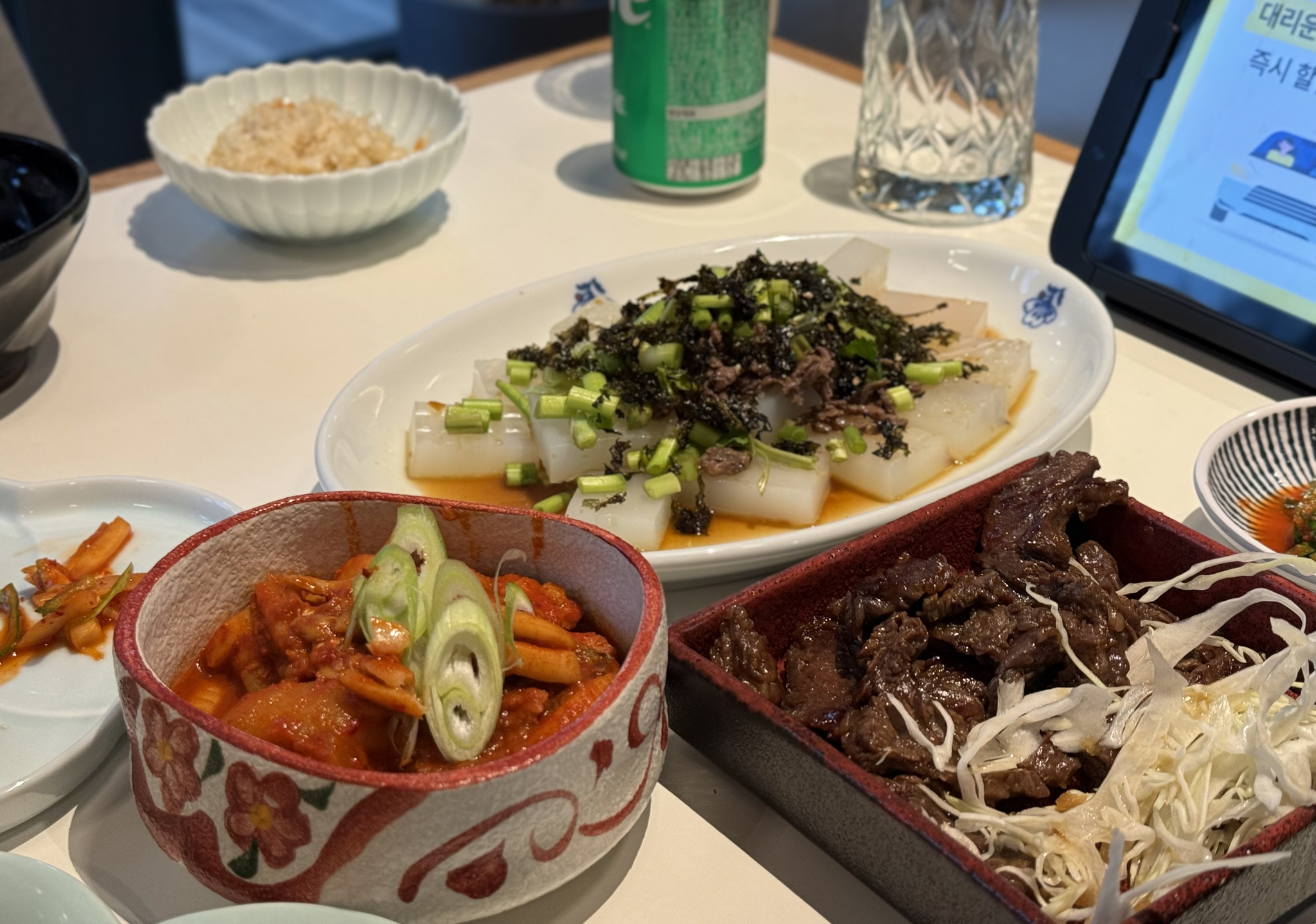Boneless boiled fish, grilled beef and mung bean jelly salad with toppings of seaweed and bulgogi were served for dinner at Surak Hyu in Nowon District in northern Seoul on June 28. [LEE SOO-JUNG]