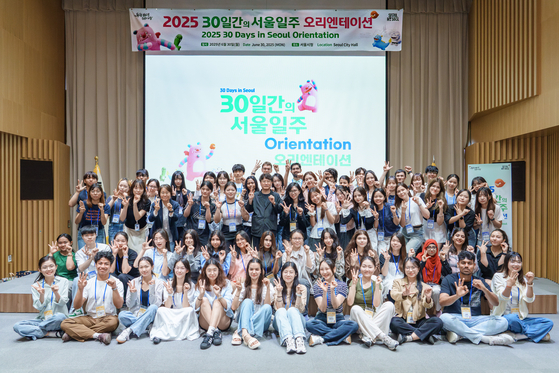 International students pose for a photo during the orientation for the “30 Days in Seoul” program at City Hall in central Seoul on June 30. [SEOUL METROPOLITAN GOVERNMENT]