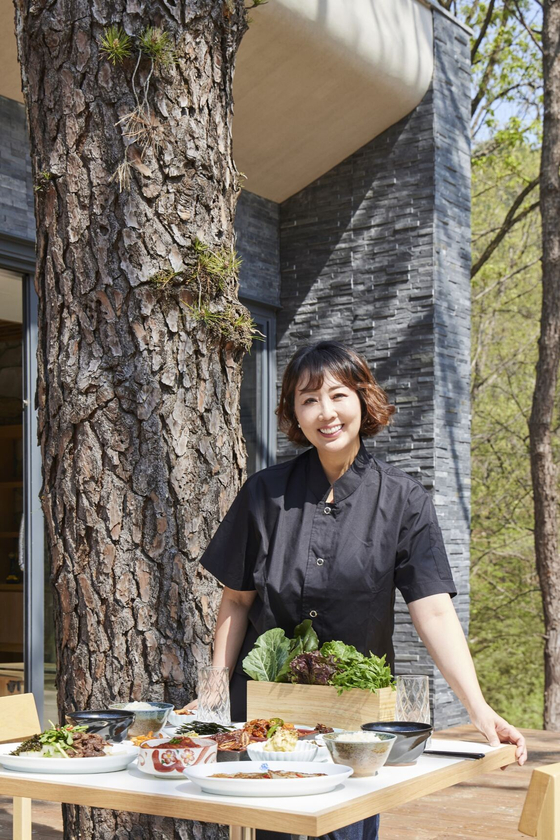 Chef Hong Shin-ae poses for a photo with food that would be served for guests staying at Surak Hyu in Nowon District in northern Seoul in an undated photo. [SURAKHYU]