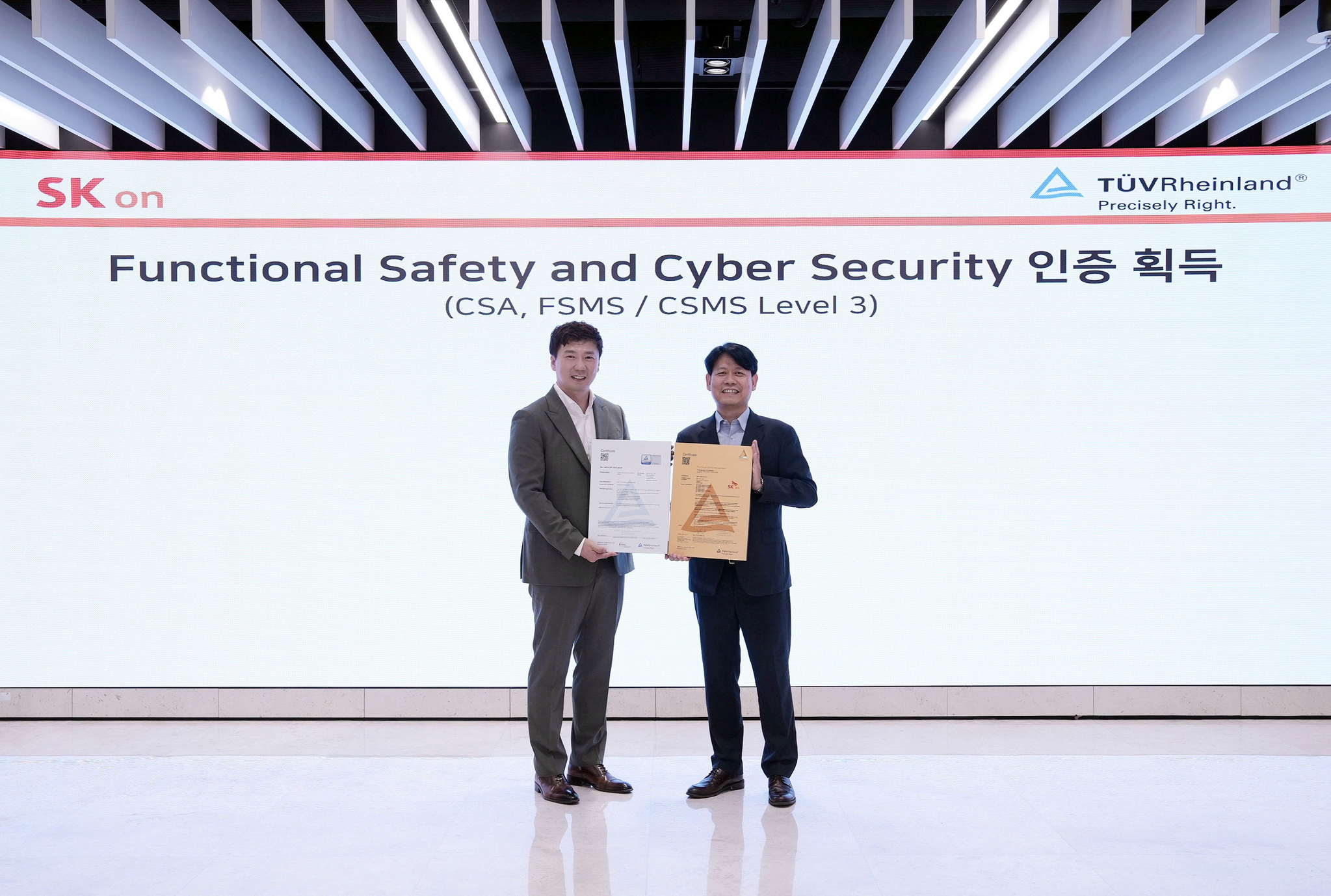 Park Ki-soo, head of R&D at SK On, right, poses for a photo with Noh Jin-pyo, head of Functional Safety & Cybersecurity in Asia Pacific at TUV Rheinland, following an international certification ceremony at SK On’s R&D Center in Daejeon on July 9. [SK ON]  