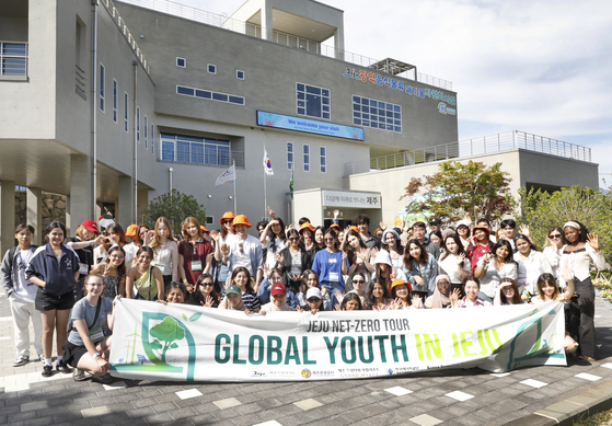 Participants of the “Global Youth in Jeju” event, part of the “Jeju Net-Zero Tour,” pose in front of the Jeju Metropolitan City Food Waste Treatment Facility on June 5. [KOREA JOONGANG DAILY]